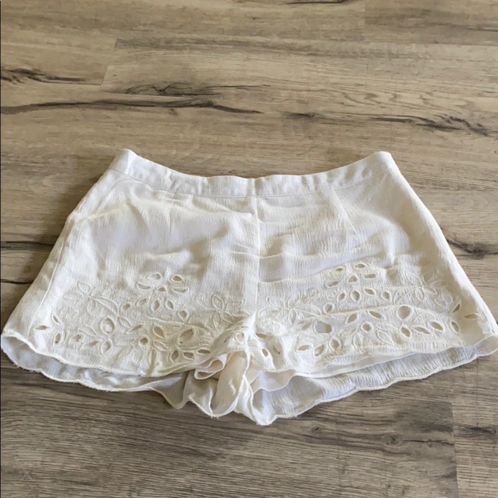 White canvas shorts with floral cut outs